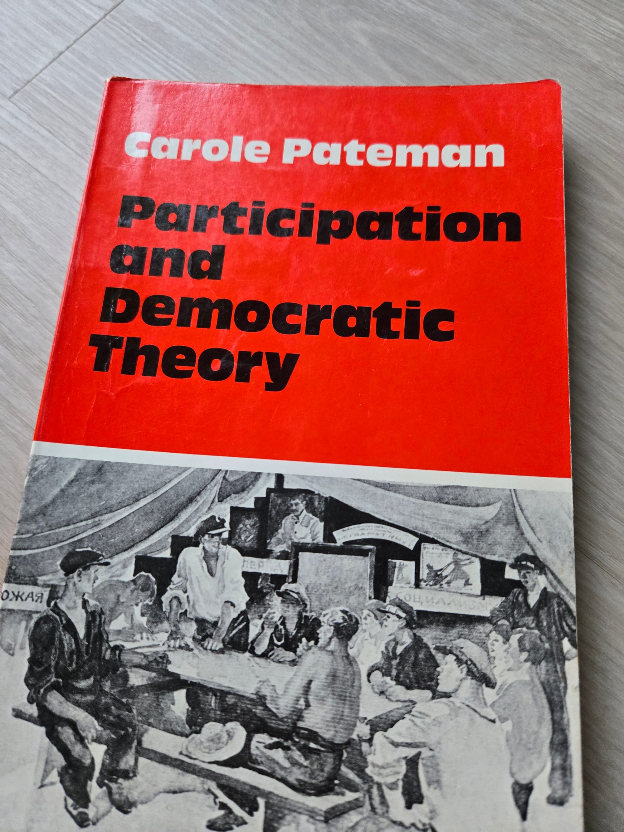 A copy of Carole Pateman's book, Participation and Democratic Theory, featuring Yugoslav workers' negotiating on the cover